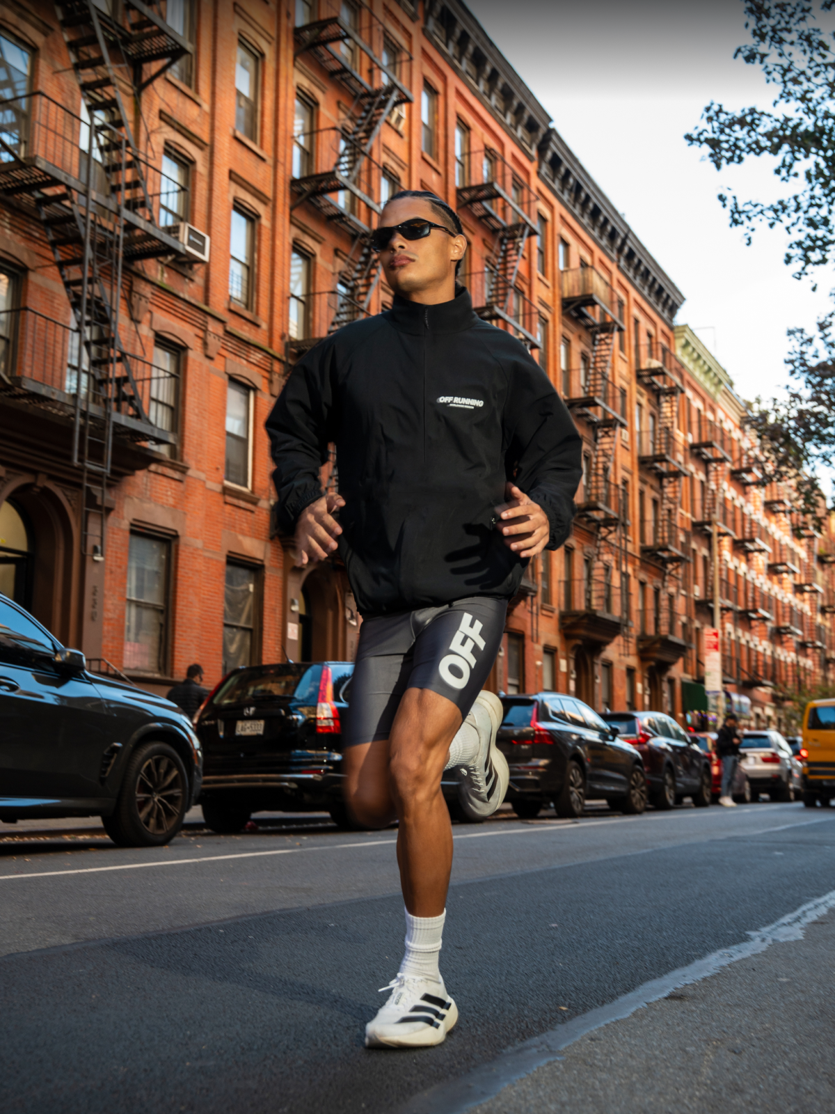 Person wearing an OFF RUNNING jacket standing in a forest